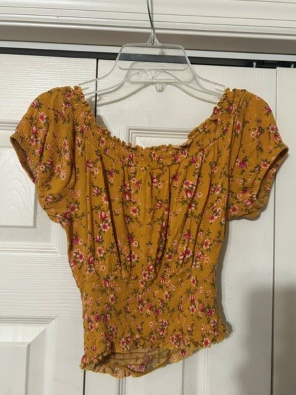 Self by Self Esteem golden glow yellow floral off-the-shoulder smocked crop top.